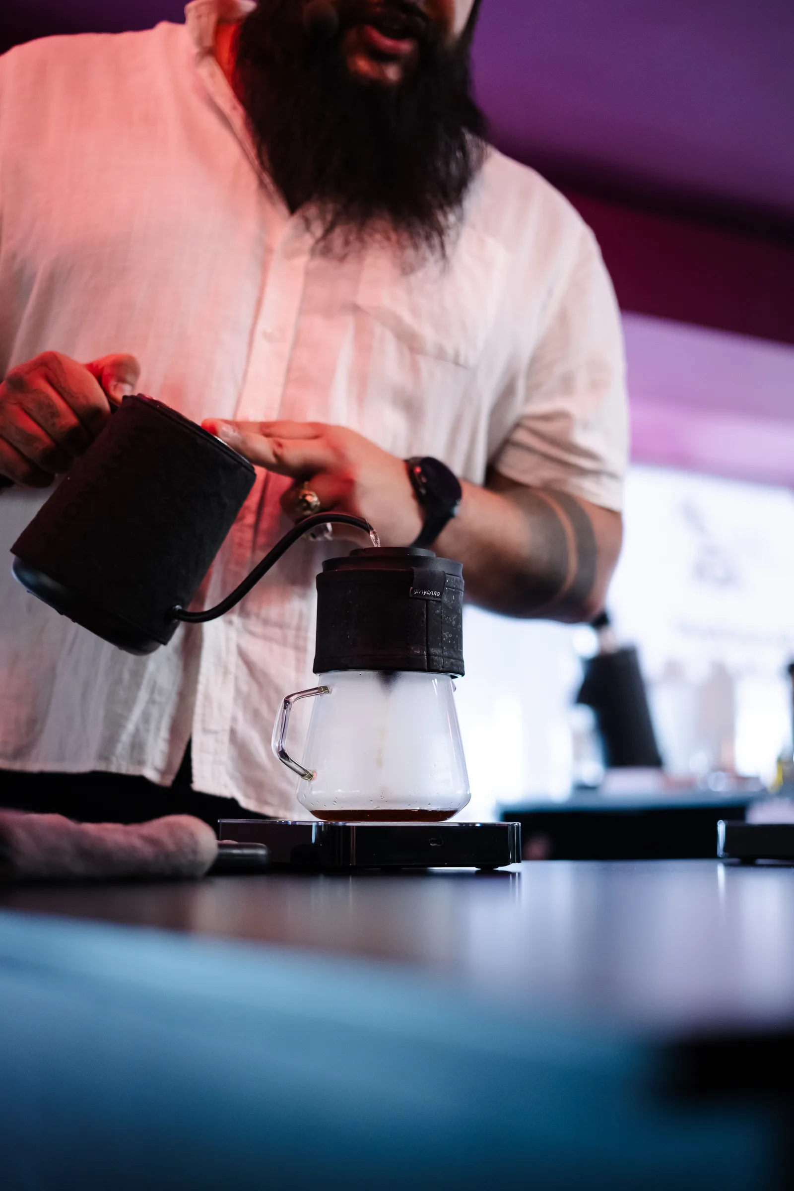 Barista brewing with the Graycano Dripper on a competition stage