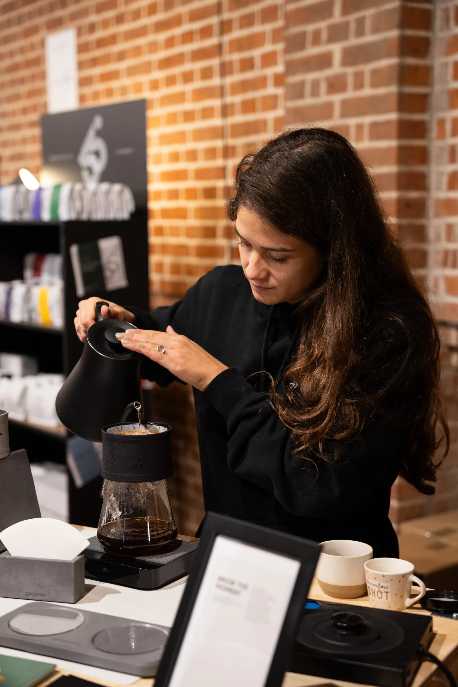 Nicole brewing coffee with the Graycano Dripper